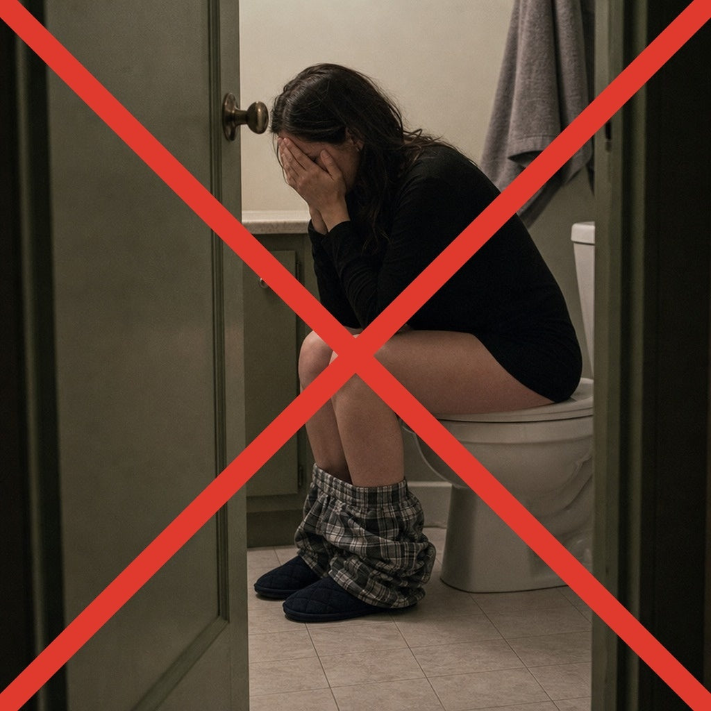 A woman doubled over on a toilet during a harsh cleanse, crossed out