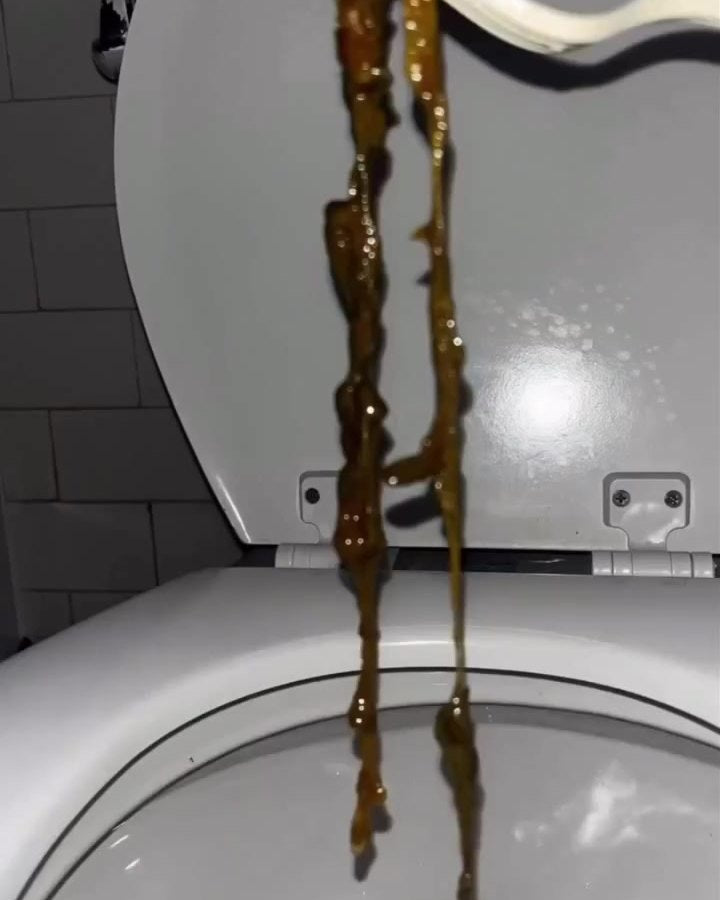 Long strands held up over a toilet